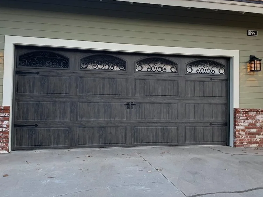Clopay Gallery Collection charcoal-woodgrain carriage-house garage door with arched decorative windows — Reynolds Hudson Valley NY install